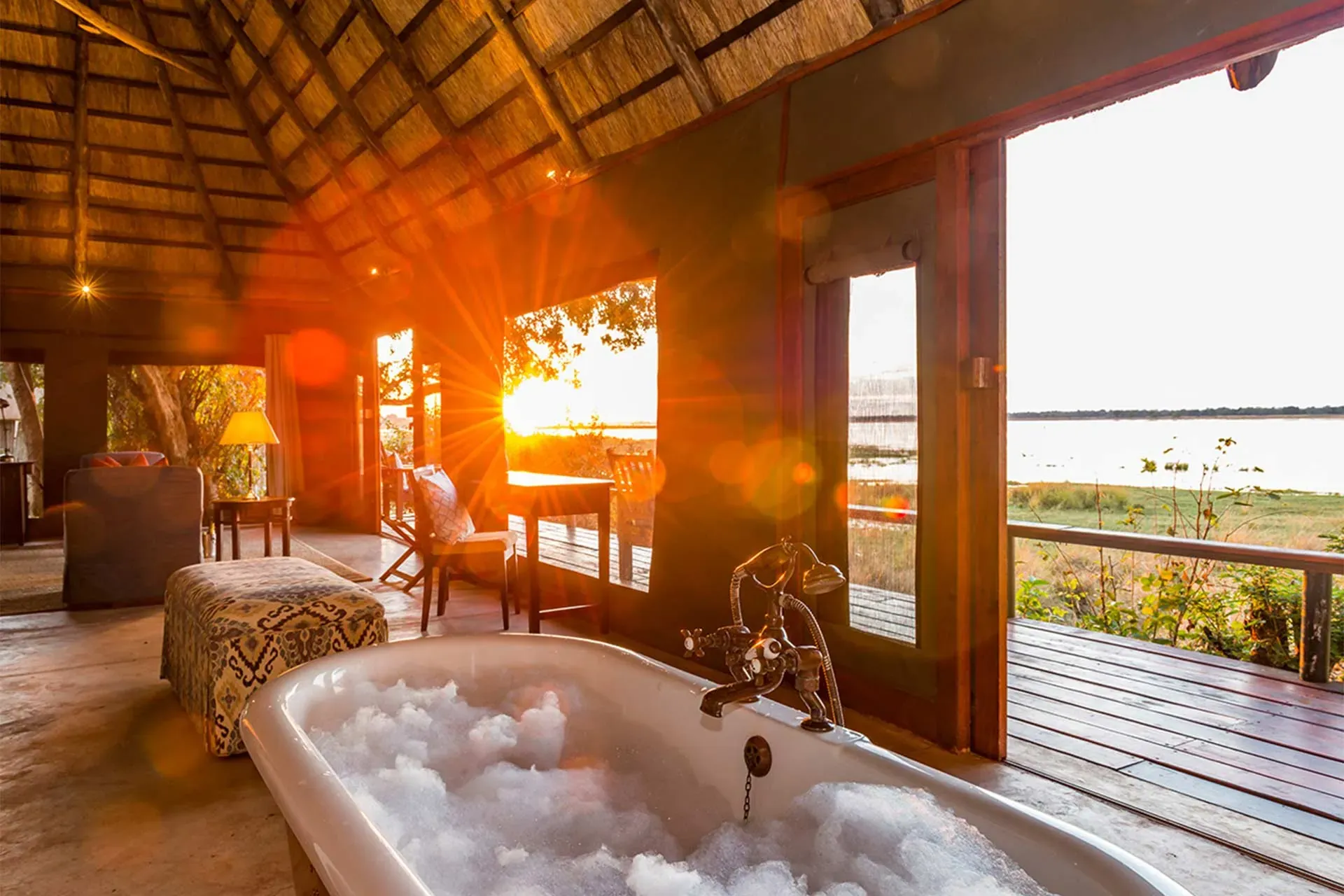 Luxurious open-air lounge area at Royal Zambezi Lodge with warm lighting and comfortable seating overlooking the river