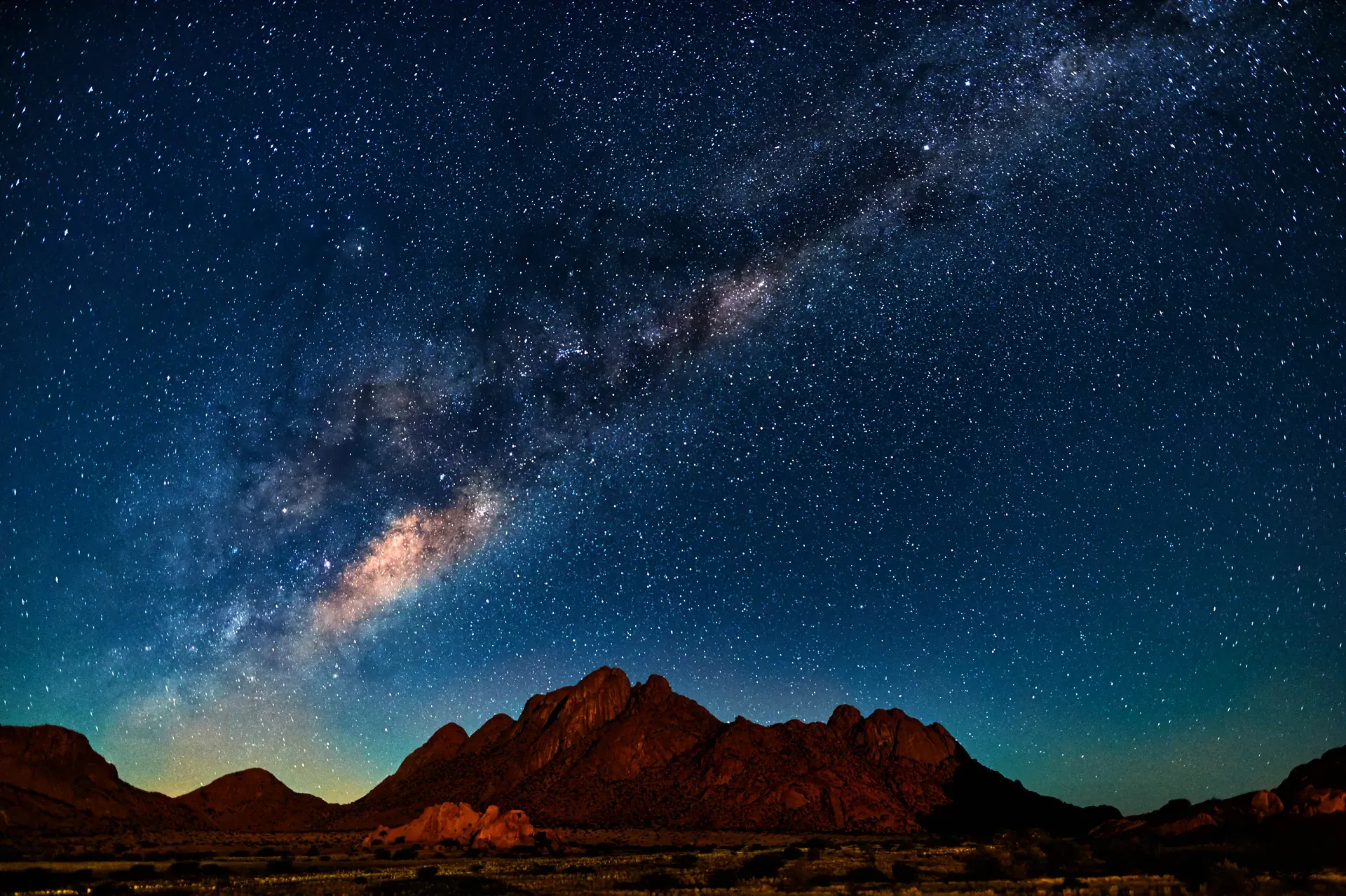Clear night sky filled with stars and the Milky Way above silhouetted hills for a stargazing experience