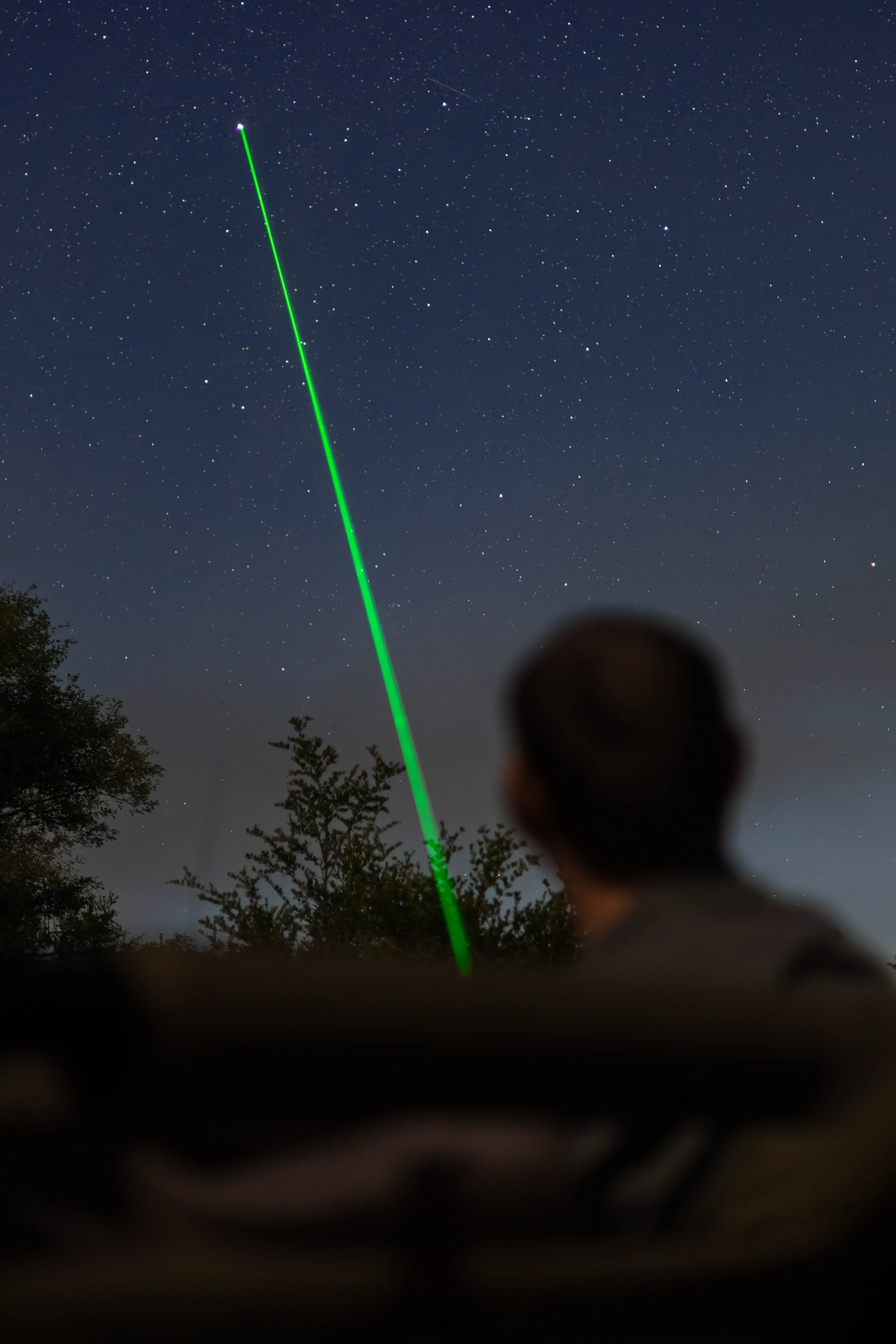Field guide showing guests the stars with a laser pointer at Monwana Lodge, sharing expert knowledge.
